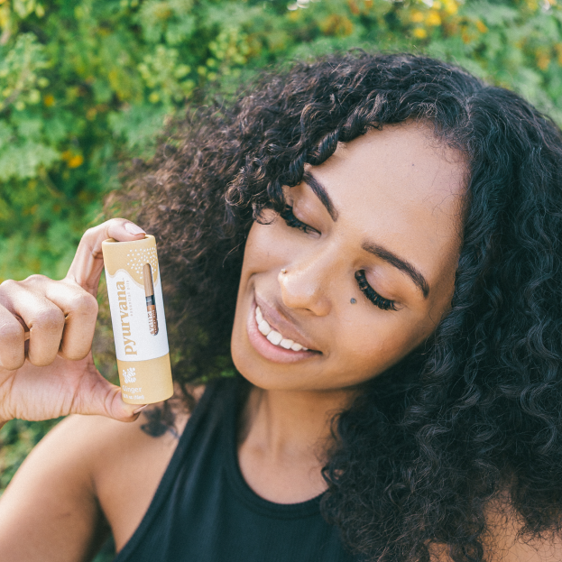 Model holding ginger essential oil
