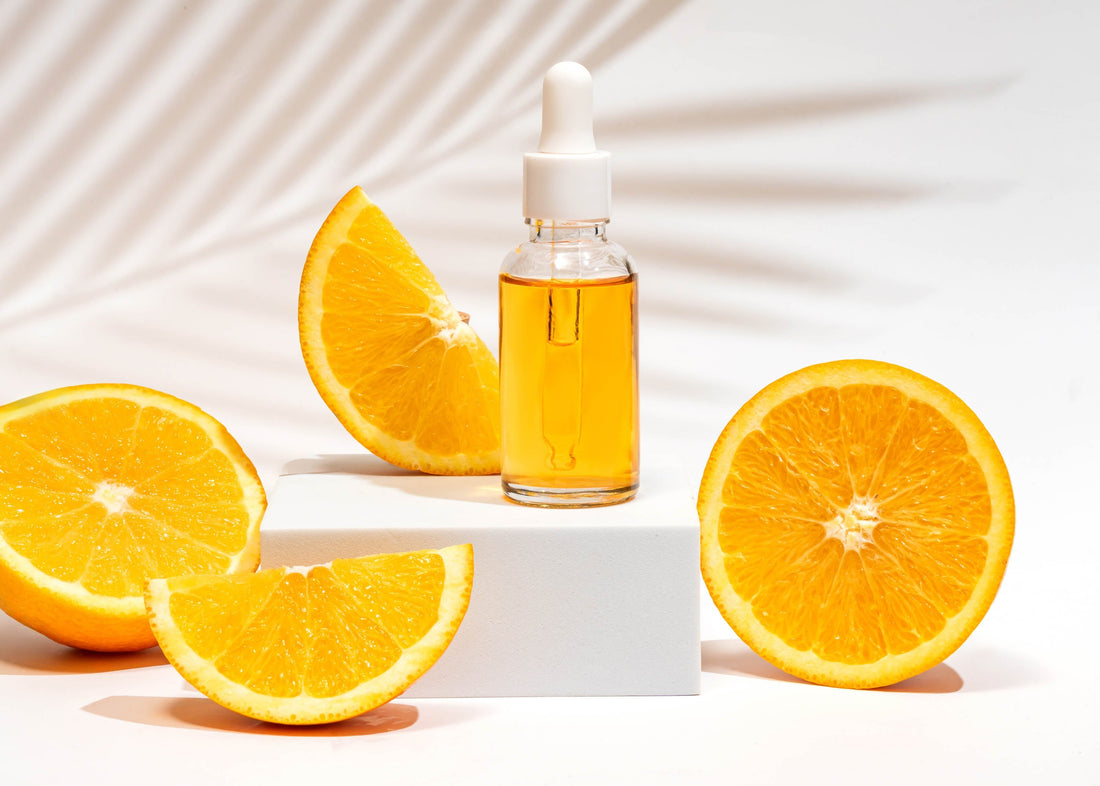 pyurvana citrus essential oil along with orange slices nearby
