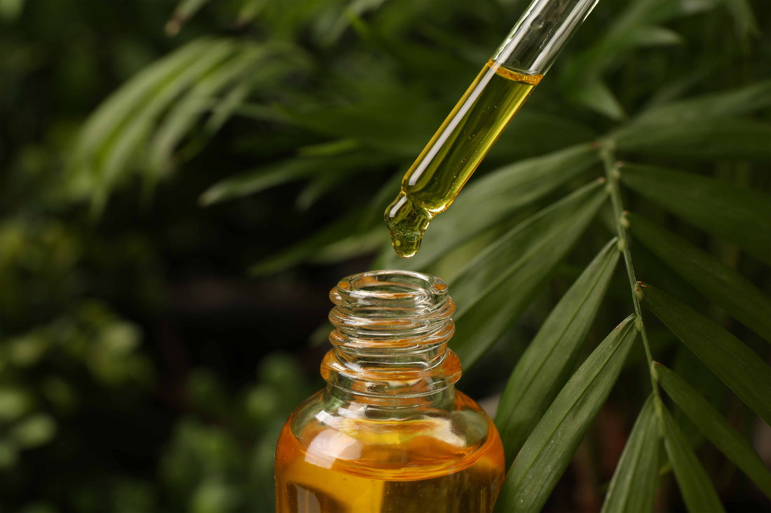 dropper adding pyurvana essential oil to glass bottle