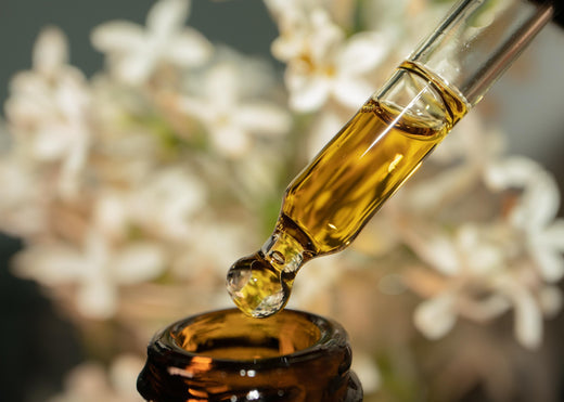 essential oil being taken from the oil bottle