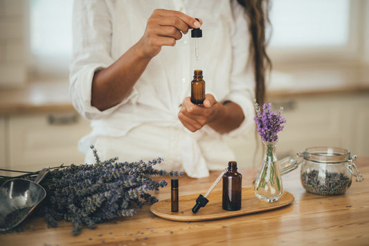 a girl taking out pyurvana essential oil from the bottle to apply on her body