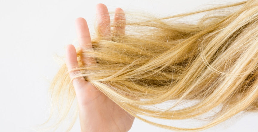 girl hand on her hair to detangle frizzy hair