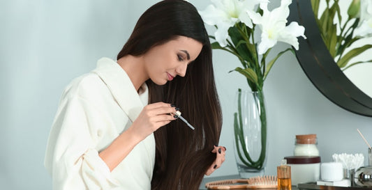 a girl applying pyurvana essential oil on her hair