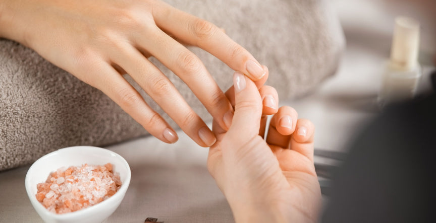 a woman maintaining her finger cuticles for healthy nail