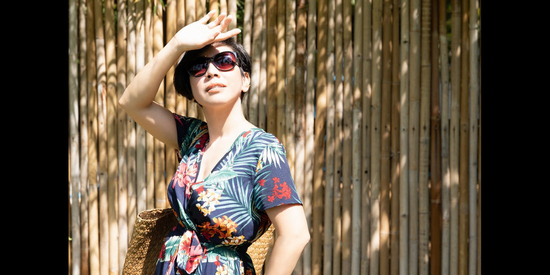 a girl covering her face with hand to get protected from sun ray