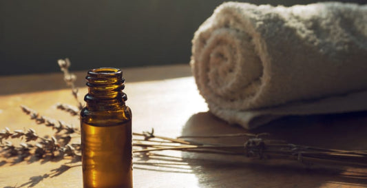 pyurvana essential oil being placed near dried leaves and towel