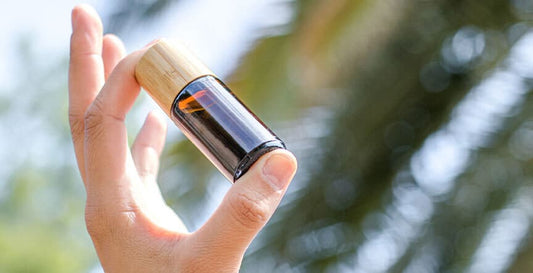 a hand carrying pyurvana essential oil bottle