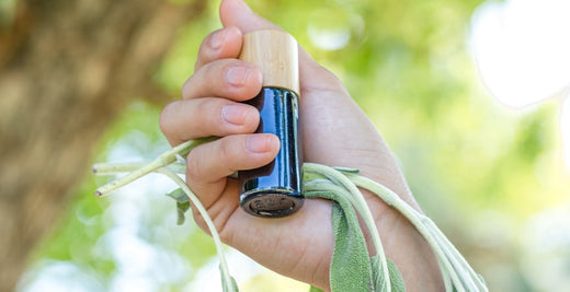 a girl holding pyurvana essential oil along with the leaves